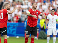 Konrad Laimer, Marko Arnautovic  are playing during the UEFA Euro 2024 Group D match between Poland v Austria, at the Olympiastadion in Berl...