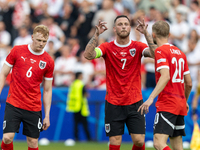 Nicolas Seiwald, Marko Arnautovic, Konrad Laimer  are playing during the UEFA Euro 2024 Group D match between Poland v Austria, at the Olymp...