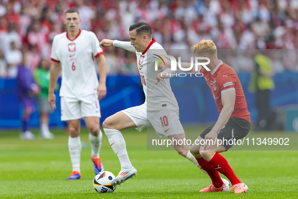 Piotr Zielinski, Nicolas Seiwald  are playing during the UEFA Euro 2024 Group D match between Poland v Austria, at the Olympiastadion in Ber...