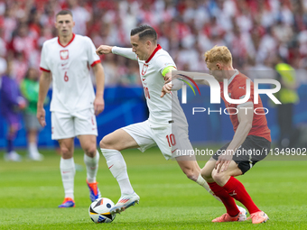 Piotr Zielinski, Nicolas Seiwald  are playing during the UEFA Euro 2024 Group D match between Poland v Austria, at the Olympiastadion in Ber...