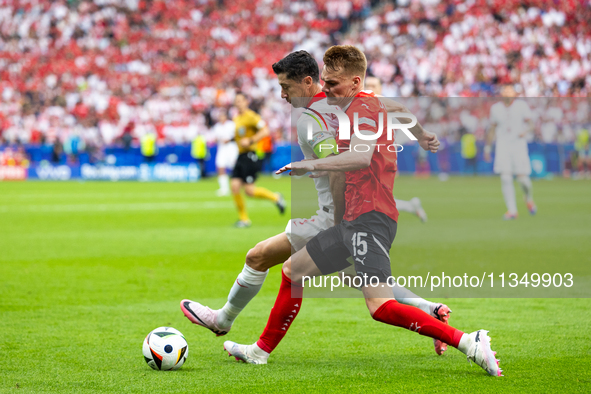 Robert Lewandowski, Philipp Lienhart are playing during the UEFA Euro 2024 Group D match between Poland v Austria, at the Olympiastadion in...