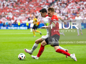 Robert Lewandowski, Philipp Lienhart are playing during the UEFA Euro 2024 Group D match between Poland v Austria, at the Olympiastadion in...