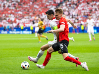 Robert Lewandowski, Philipp Lienhart are playing during the UEFA Euro 2024 Group D match between Poland v Austria, at the Olympiastadion in...