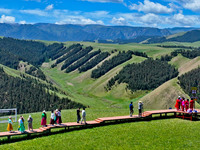 Tourists are enjoying snow-capped mountains, forests, and grasslands at the grassland section of Qilian Mountain National Park in Zhangye ci...