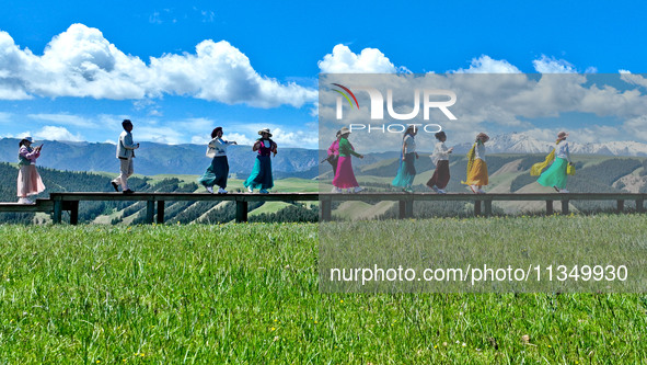 Tourists are enjoying snow-capped mountains, forests, and grasslands at the grassland section of Qilian Mountain National Park in Zhangye ci...