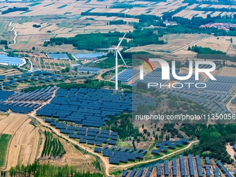 A general view of an agricultural 40 MW new energy photovoltaic power plant is being seen in the West Coast New Area of Qingdao, Shandong pr...