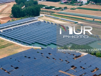 A general view of an agricultural 40 MW new energy photovoltaic power plant is being seen in the West Coast New Area of Qingdao, Shandong pr...