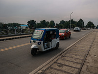 An E-Rickshaw is moving on a highway in Srinagar, Jammu and Kashmir, India, on June 22, 2024. (