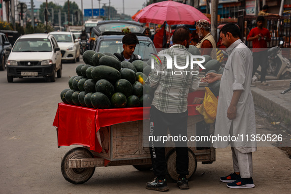 People are purchasing fruits on a cloudy day in Srinagar, Jammu and Kashmir, India, on June 22, 2024 