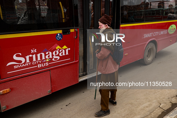 An elderly man is waiting for the Smart City Bus at a bus stop in Srinagar, Jammu and Kashmir, India, on June 22, 2024. 