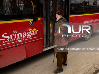 An elderly man is waiting for the Smart City Bus at a bus stop in Srinagar, Jammu and Kashmir, India, on June 22, 2024. (