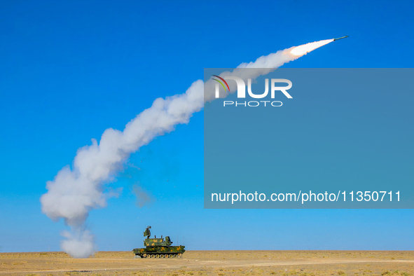 A missile is lifting off to intercept a high-altitude target during a live-fire tactical drill in Jiuquan, Gansu province, China, on June 20...