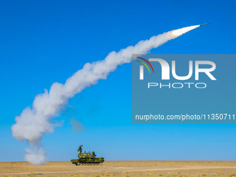 A missile is lifting off to intercept a high-altitude target during a live-fire tactical drill in Jiuquan, Gansu province, China, on June 20...