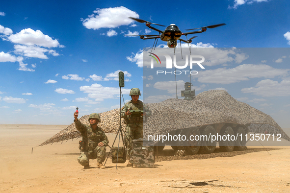 Officers and soldiers are conducting intelligence reconnaissance during a live-fire tactical exercise in Jiuquan, Gansu province, China, on...