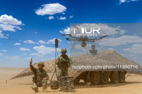 Officers and soldiers are conducting intelligence reconnaissance during a live-fire tactical exercise in Jiuquan, Gansu province, China, on...