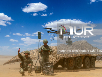 Officers and soldiers are conducting intelligence reconnaissance during a live-fire tactical exercise in Jiuquan, Gansu province, China, on...