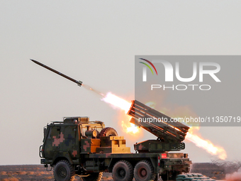 A rocket launcher unit is conducting collective fire during a live-fire tactical drill in Jiuquan, Gansu province, China, on June 20, 2024....