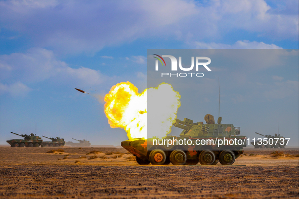 A howitzer unit is striking a target during a live-fire tactical drill in Jiuquan, Gansu province, China, on June 20, 2024. 