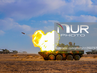 A howitzer unit is striking a target during a live-fire tactical drill in Jiuquan, Gansu province, China, on June 20, 2024. (