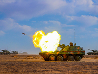 A howitzer unit is striking a target during a live-fire tactical drill in Jiuquan, Gansu province, China, on June 20, 2024. (