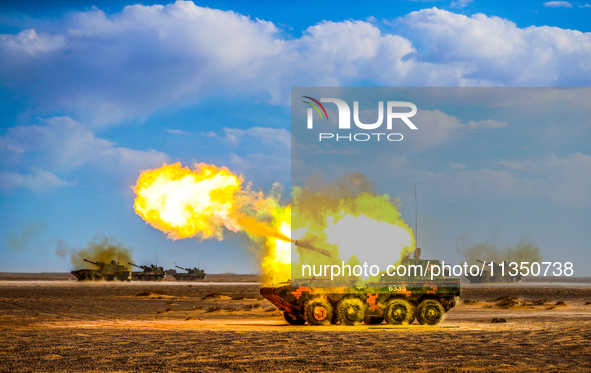 A howitzer unit is striking a target during a live-fire tactical drill in Jiuquan, Gansu province, China, on June 20, 2024. 