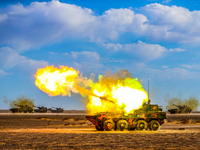 A howitzer unit is striking a target during a live-fire tactical drill in Jiuquan, Gansu province, China, on June 20, 2024. (