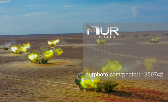 An artillery unit is covering a forward position during a live-fire tactical drill in Jiuquan, Gansu province, China, on June 20, 2024. 