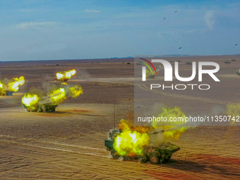 An artillery unit is covering a forward position during a live-fire tactical drill in Jiuquan, Gansu province, China, on June 20, 2024. (