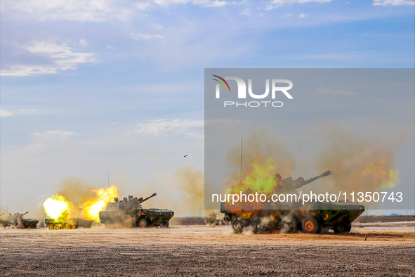 A howitzer unit is striking a target during a live-fire tactical drill in Jiuquan, Gansu province, China, on June 20, 2024. 