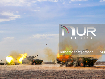 A howitzer unit is striking a target during a live-fire tactical drill in Jiuquan, Gansu province, China, on June 20, 2024. (