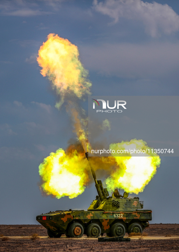 An artillery unit is conducting extreme firing during a live-fire tactical drill in Jiuquan, Gansu province, China, on June 20, 2024. 