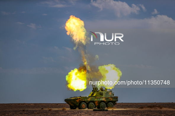 An artillery unit is conducting extreme firing during a live-fire tactical drill in Jiuquan, Gansu province, China, on June 20, 2024. 