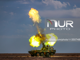 An artillery unit is conducting extreme firing during a live-fire tactical drill in Jiuquan, Gansu province, China, on June 20, 2024. (