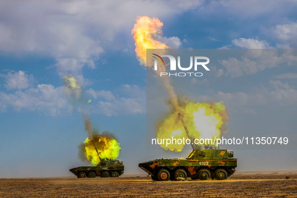 An artillery unit is conducting extreme firing during a live-fire tactical drill in Jiuquan, Gansu province, China, on June 20, 2024. 