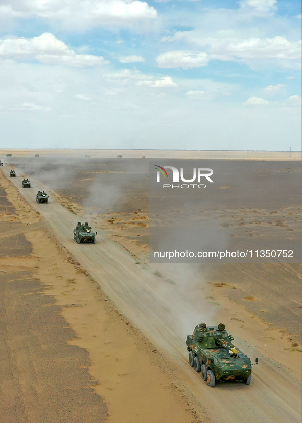 Artillery units are moving rapidly towards the assembly area during a live-fire tactical drill in Jiuquan, China, on June 20, 2024. 