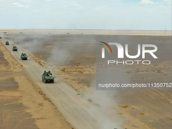 Artillery units are moving rapidly towards the assembly area during a live-fire tactical drill in Jiuquan, China, on June 20, 2024. (