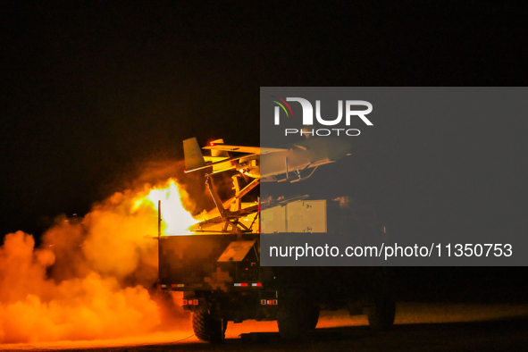 A drone is taking off at night to conduct aerial reconnaissance during a live-fire tactical drill in Jiuquan, Gansu province, China, on June...