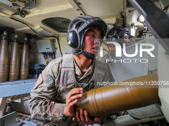 A Chinese soldier is loading ammunition during a live-fire tactical drill in Jiuquan, Gansu province, China, on June 20, 2024. (