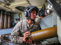 A Chinese soldier is loading ammunition during a live-fire tactical drill in Jiuquan, Gansu province, China, on June 20, 2024. (