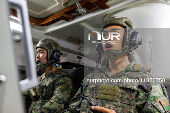 A command terminal operator is giving a quick order during a live-fire tactical drill in Jiuquan, Gansu province, China, on June 20, 2024. 