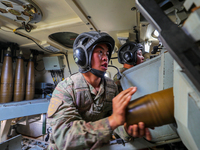 A Chinese soldier is loading ammunition during a live-fire tactical drill in Jiuquan, Gansu province, China, on June 20, 2024. (