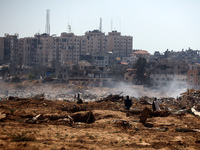 Palestinian men are searching for recyclables at a garbage dump in al-Bureij refugee camp in the central Gaza Strip, on June 22, 2024, amid...