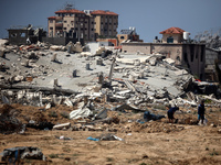 Palestinians are making their way past destroyed buildings in al-Bureij refugee camp in the central Gaza Strip, on June 22, 2024, amid the o...