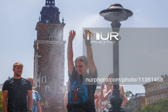 A water mist sprinkler at the Main Square in Krakow, Poland on June 21, 2024. 