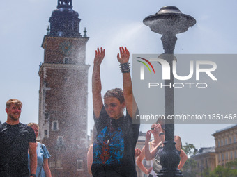 A water mist sprinkler at the Main Square in Krakow, Poland on June 21, 2024. (