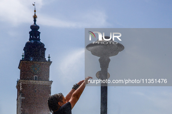 A water mist sprinkler at the Main Square in Krakow, Poland on June 21, 2024. 