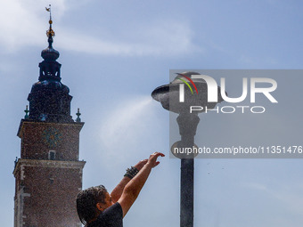 A water mist sprinkler at the Main Square in Krakow, Poland on June 21, 2024. (