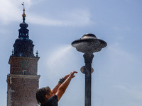 A water mist sprinkler at the Main Square in Krakow, Poland on June 21, 2024. (