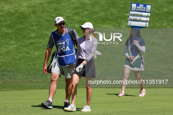 Sarah Schmelzel of Phoenix, Arizona walks with her caddie followed by the standard bearer on the 18th fairway during the second round of the...