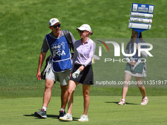 Sarah Schmelzel of Phoenix, Arizona walks with her caddie followed by the standard bearer on the 18th fairway during the second round of the...